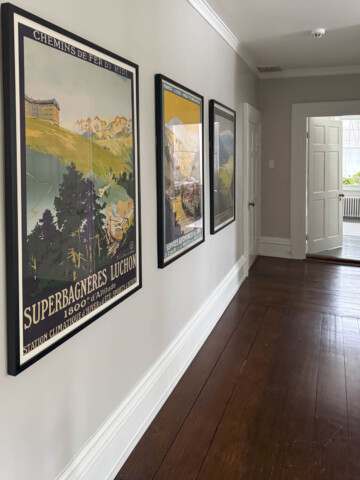 collingwood on walls with brightly colored framed vintage posters