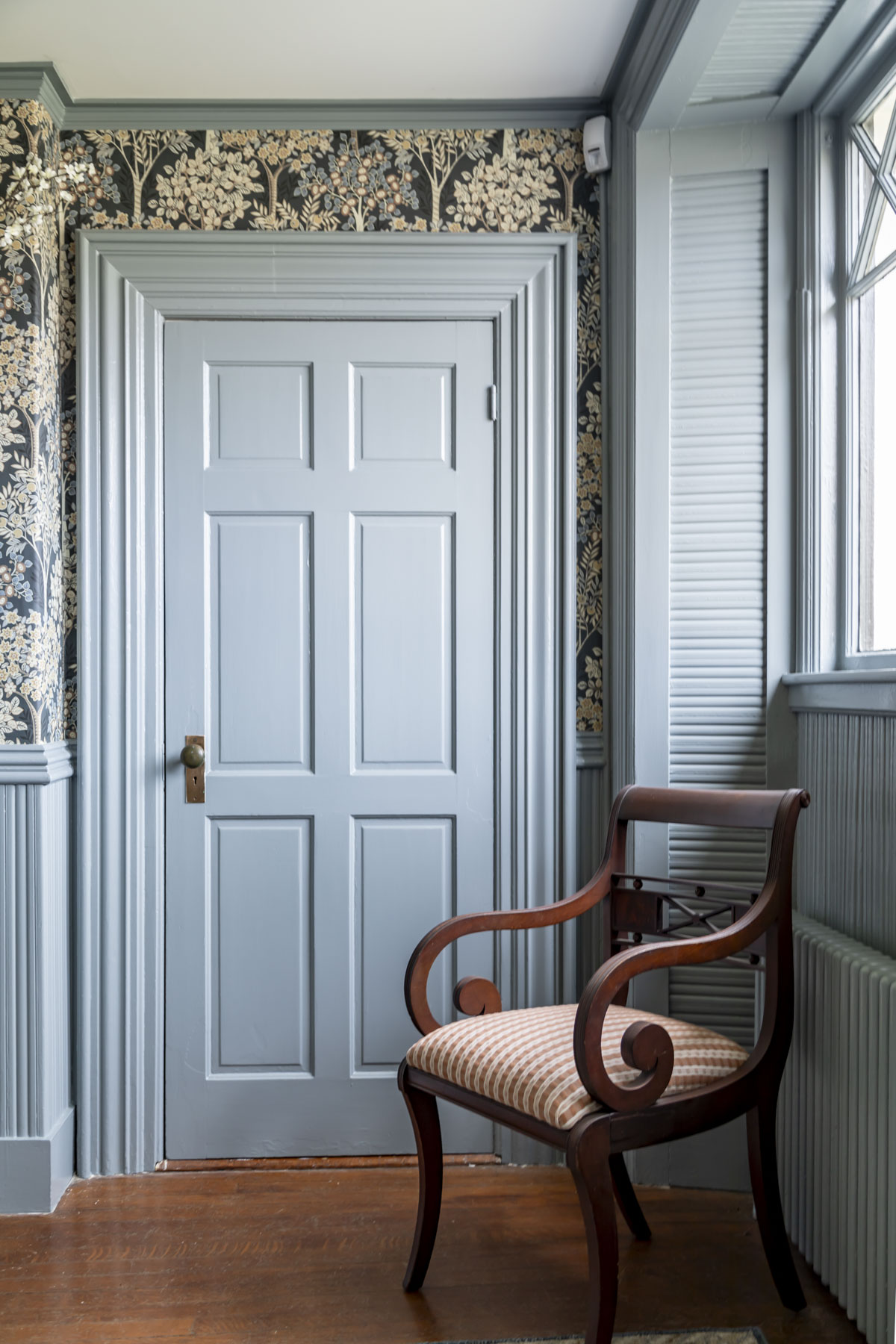 Brewster Gray on a door with trim work all painted as well with a wooden antique chair