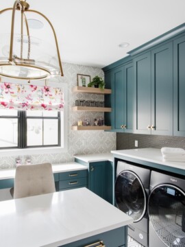 deep teal cabinets in a laundry room