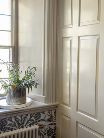 a khaki wall with wood paneling