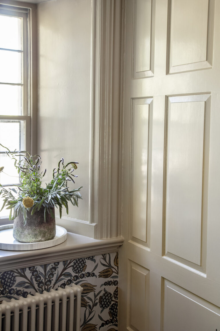 a khaki wall with wood paneling