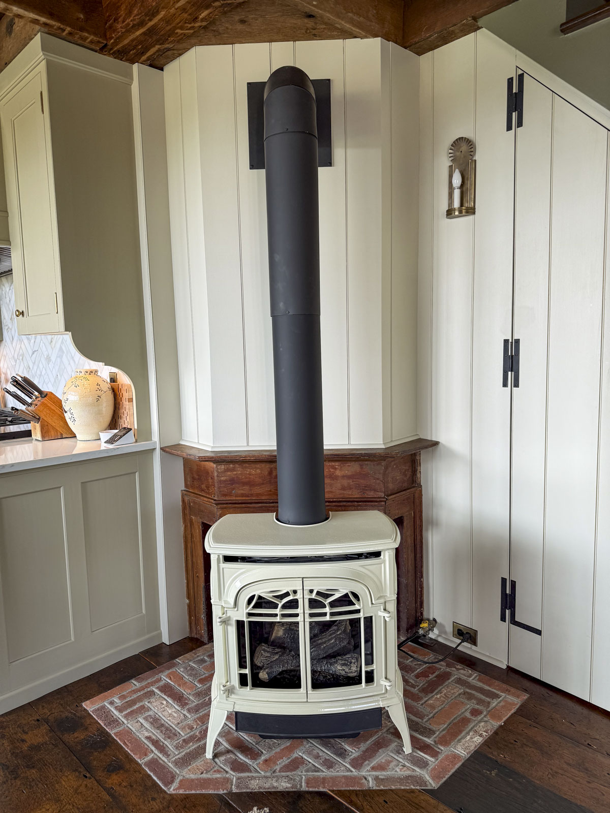 our gas burning stove in front of the wooden boards on the walls