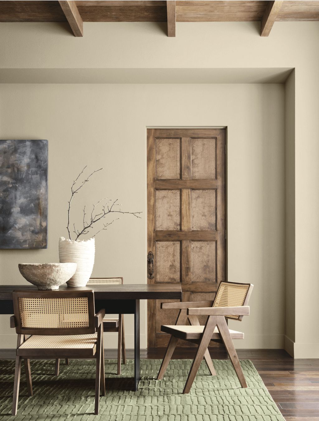 a dining room with wood tones and khaki walls