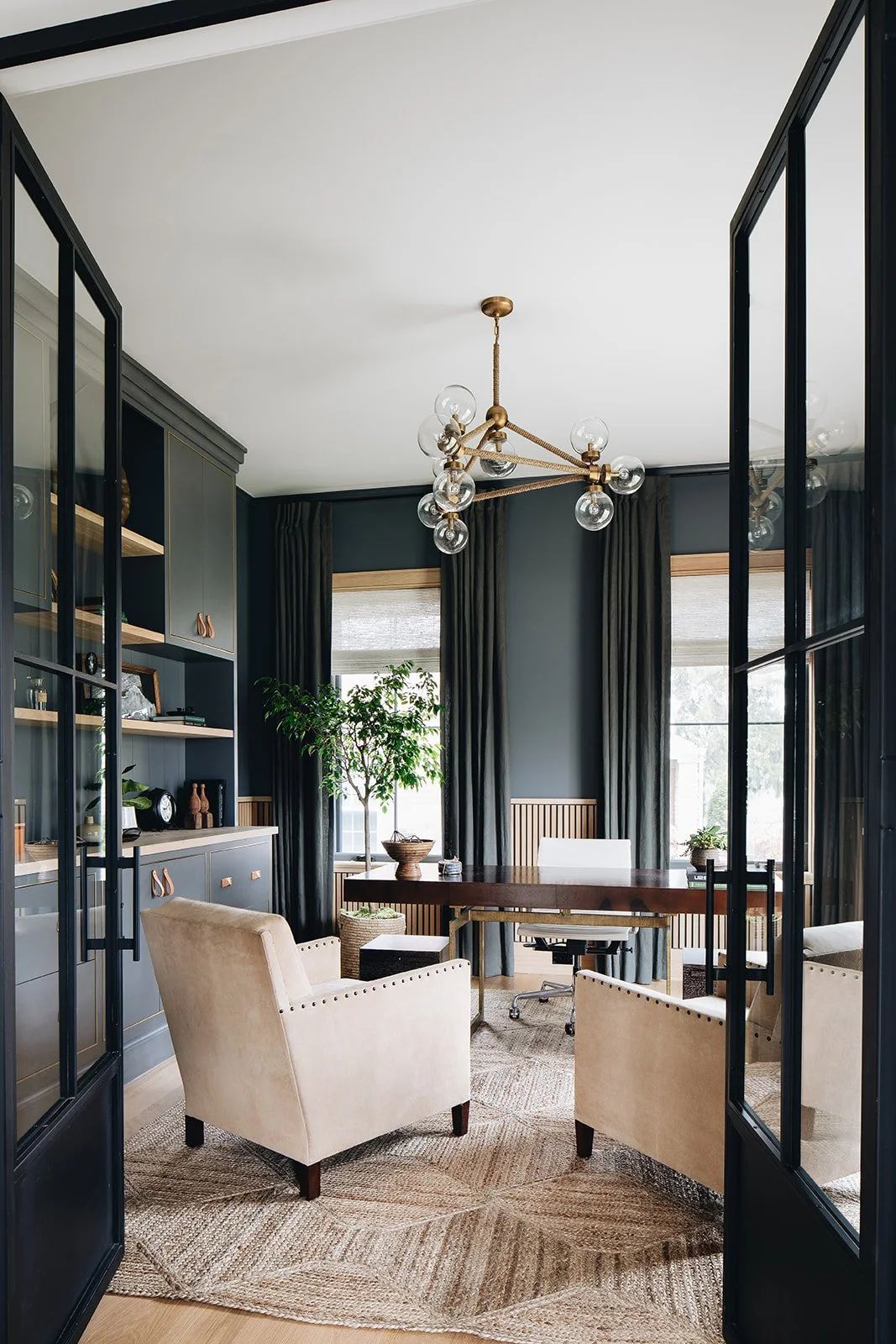 stunning library space with a wet bar, floor to ceiling drapes and deepest charcoal teal walls- just a click away from true black- gives the space a velvety feel without brashness.