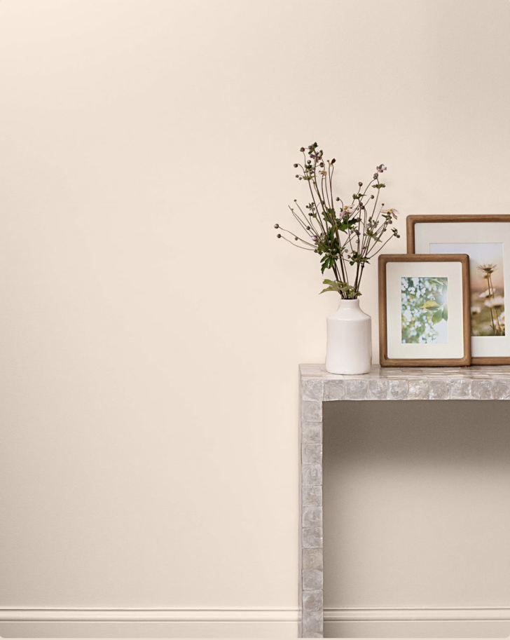 rendering of tissue pink in a room with a side table and vase of flowers