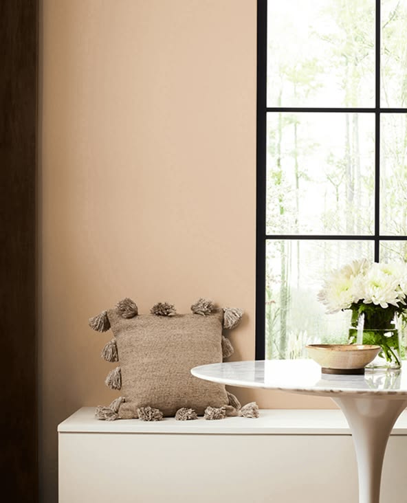 colonial revival tan walls with black window sashes and a window seat banquette with a throw pillow with tassles