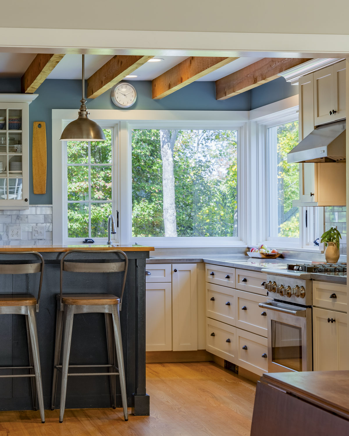 kitchen with beams on the ceiling and white painted cabinets