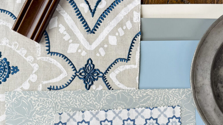 A flatlay of blues, gray and white including fabric, wallpaper, paint and hard surface materials