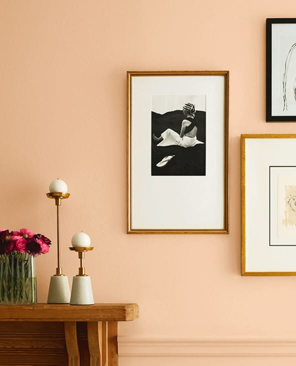 sociable by sherwin williams painted on a wall with framed artwork and a side table with contemporary accents and a flower arrangement