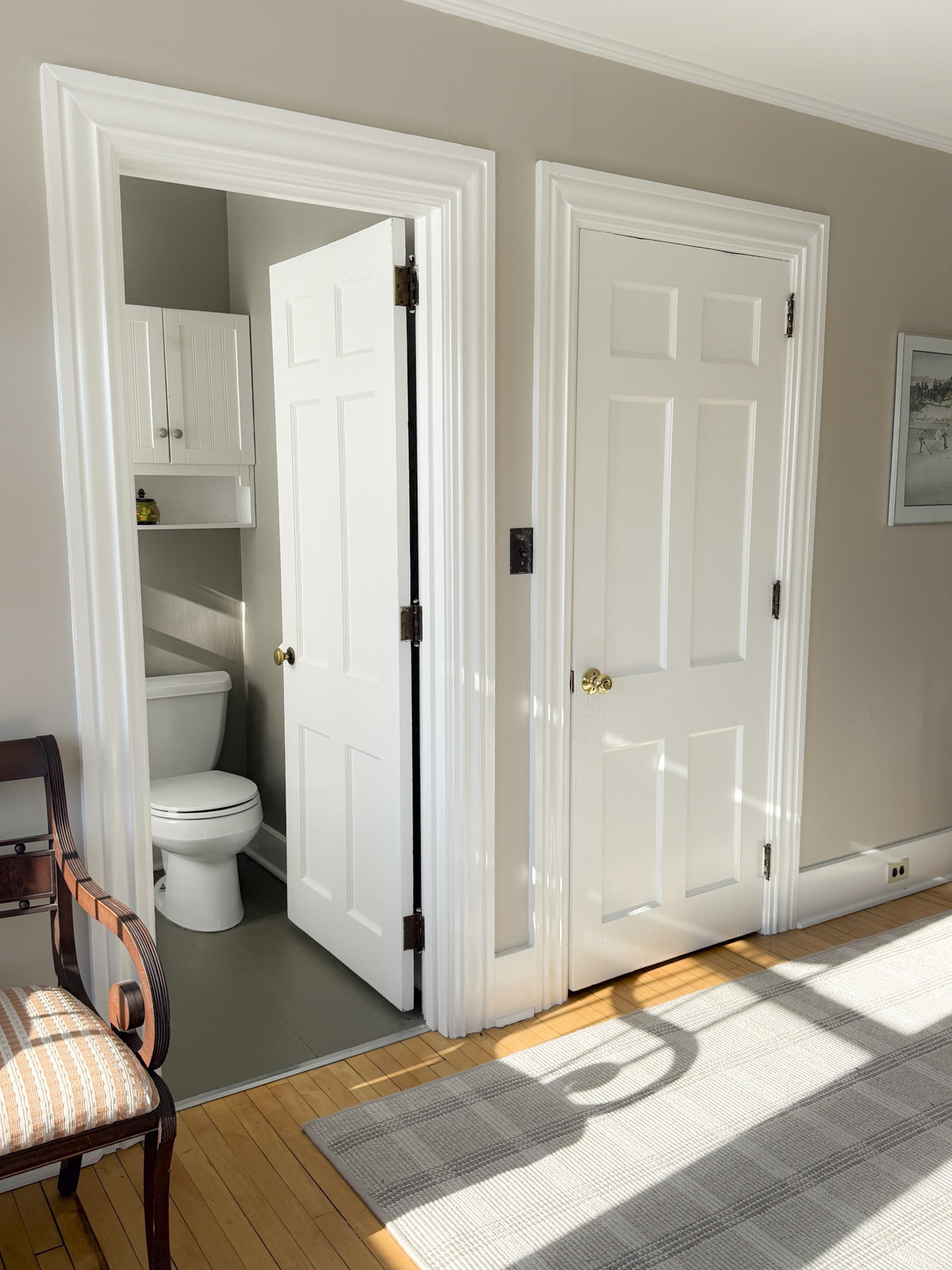 guest room in our house with the door open to the bathroom which is painted Indian River