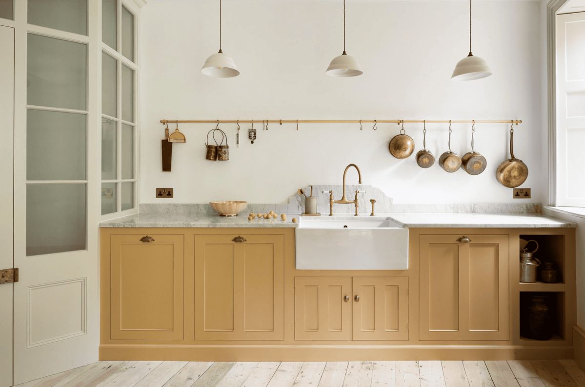 DeVol yellow kitchen cabinets with creamy white and cream walls and trim