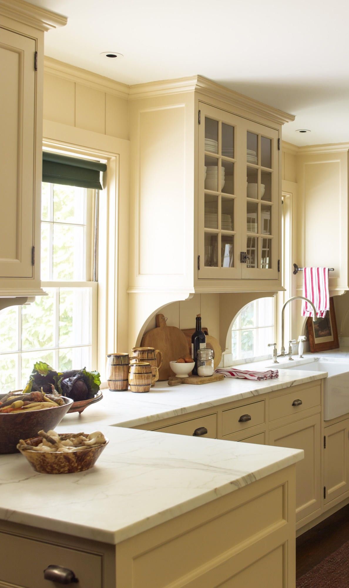 Creamy gold painted cabinets give this kitchen a time-honored feel