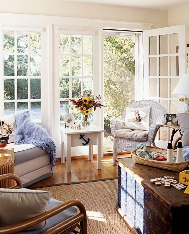 Creamy neutral walls and bright off-white trim are the perfect relaxed vibe for blue and white furnishings and natural woven textures in a beach house or coastal home in New England