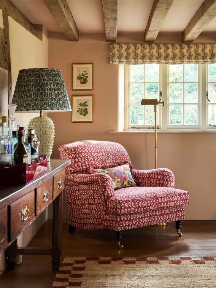 peach room with red upholstered chair