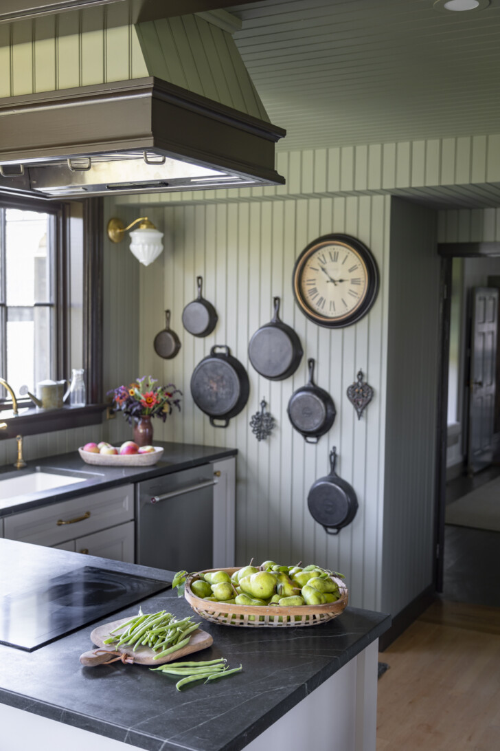 charming country kitchen with cast iron pan display wall 