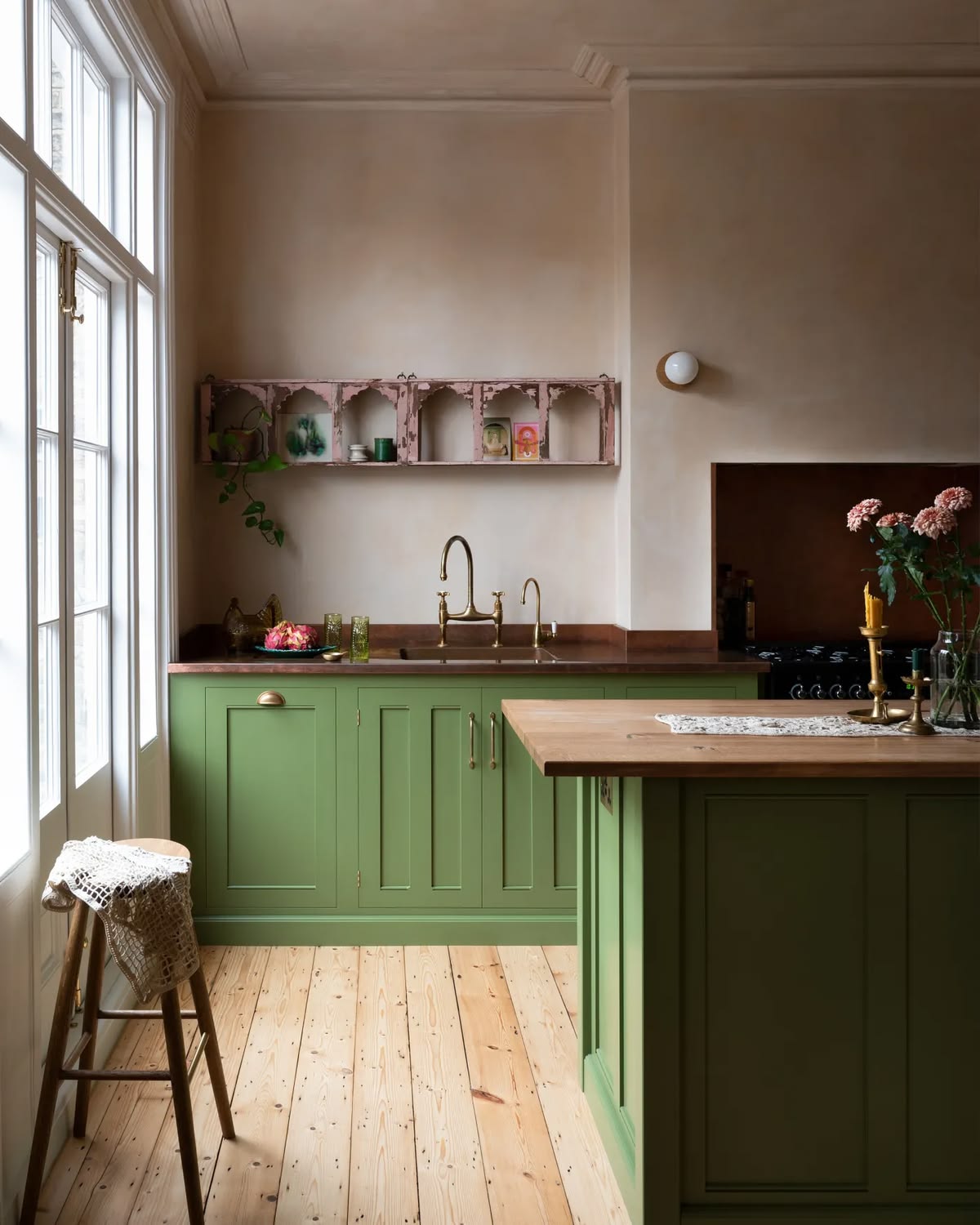 splashy green cabinetry is paired with soft and velvety peach plaster walls