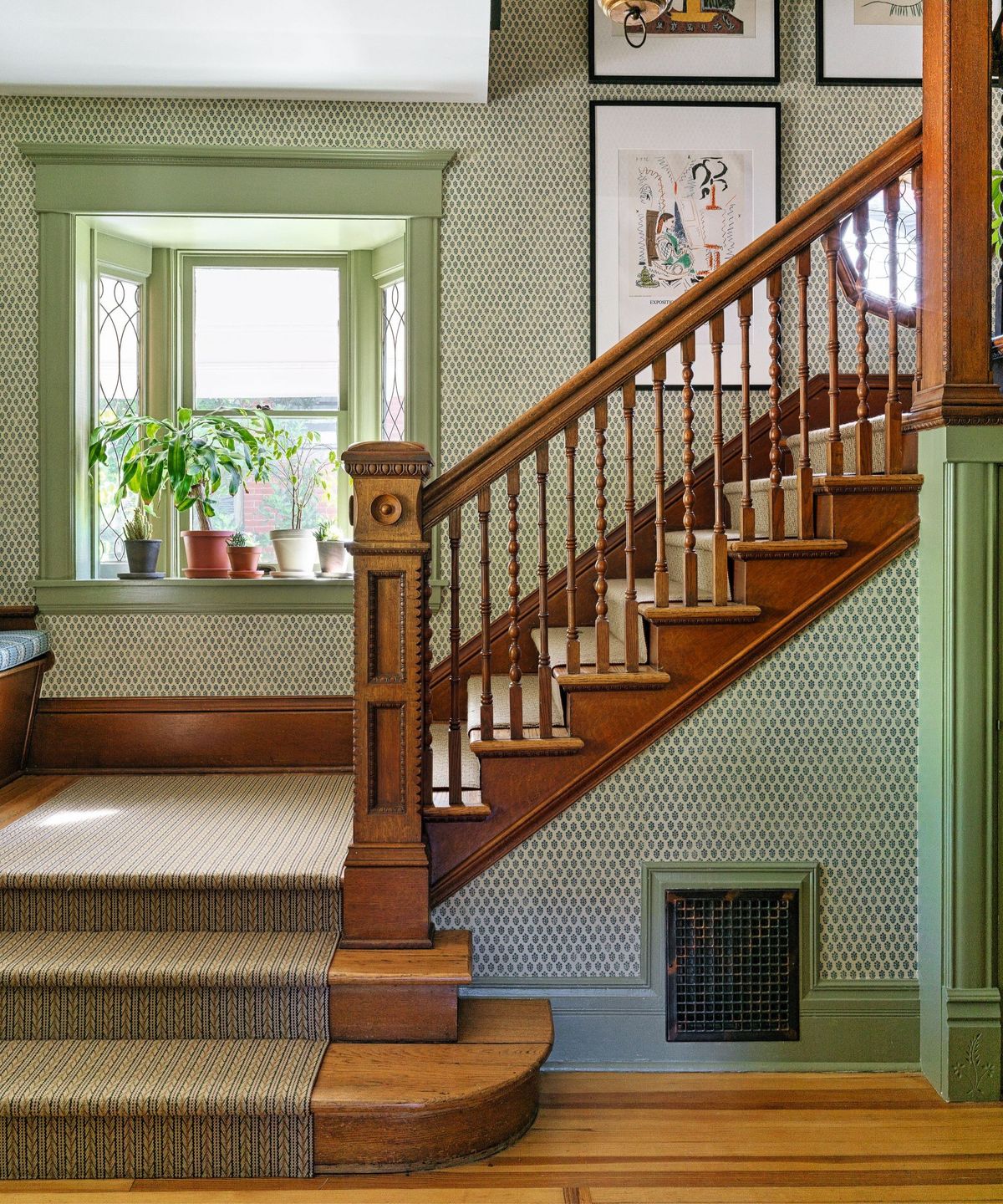 green trim with wallpaper in an entry hall and stairwell