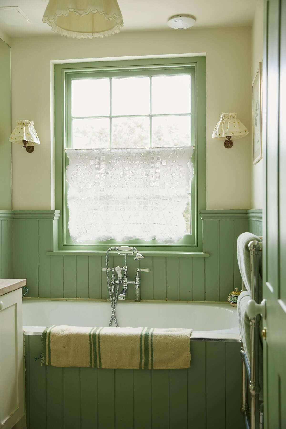green wainscoting in a bathroom paired with yellow walls