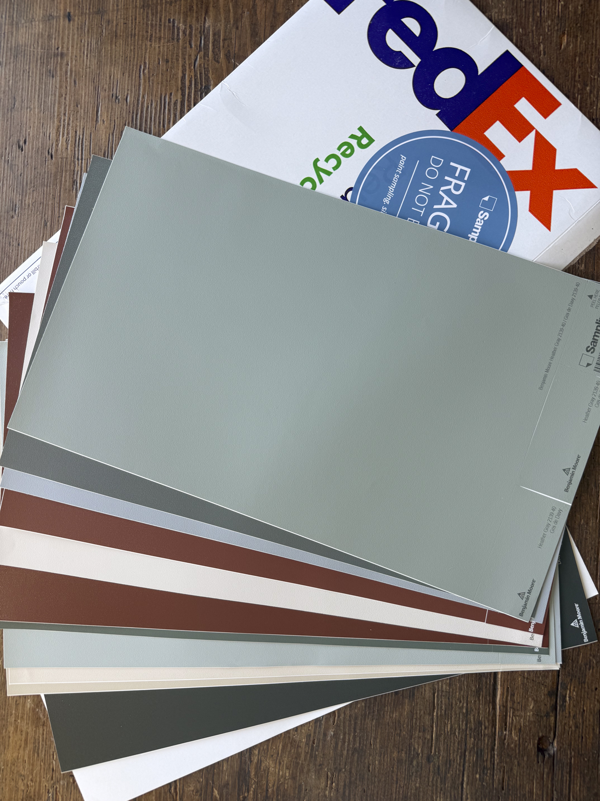 sample sheets from Samplize that arrived in a Fed Ex envelope on a wooden table